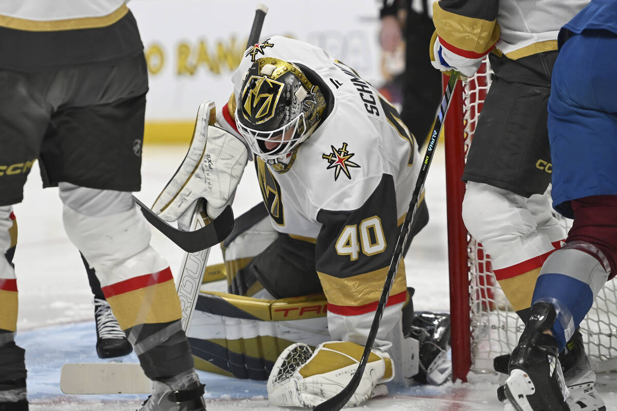 Vegas Golden Knights goaltender Akira Schmid (40) covers a puck during in the first period of a ...