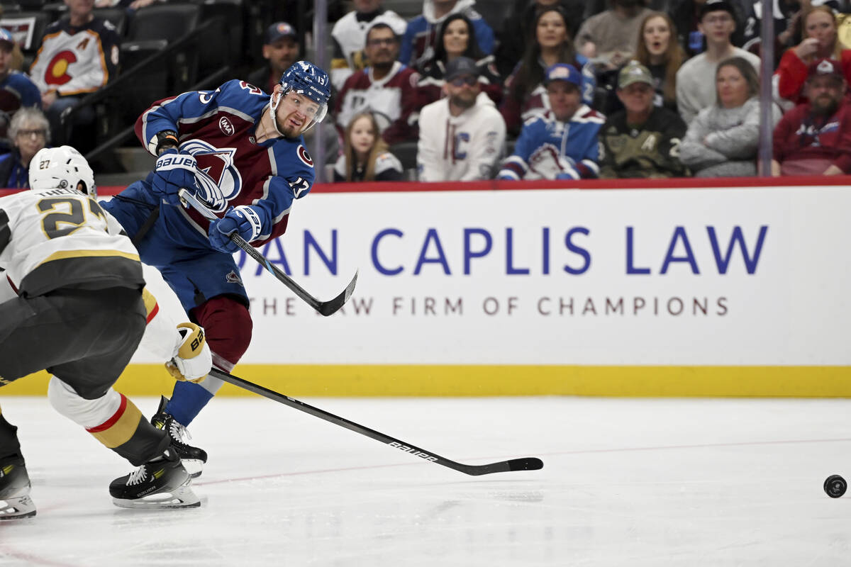Vegas Golden Knights defenseman Shea Theodore (27) defends against Colorado Avalanche right win ...