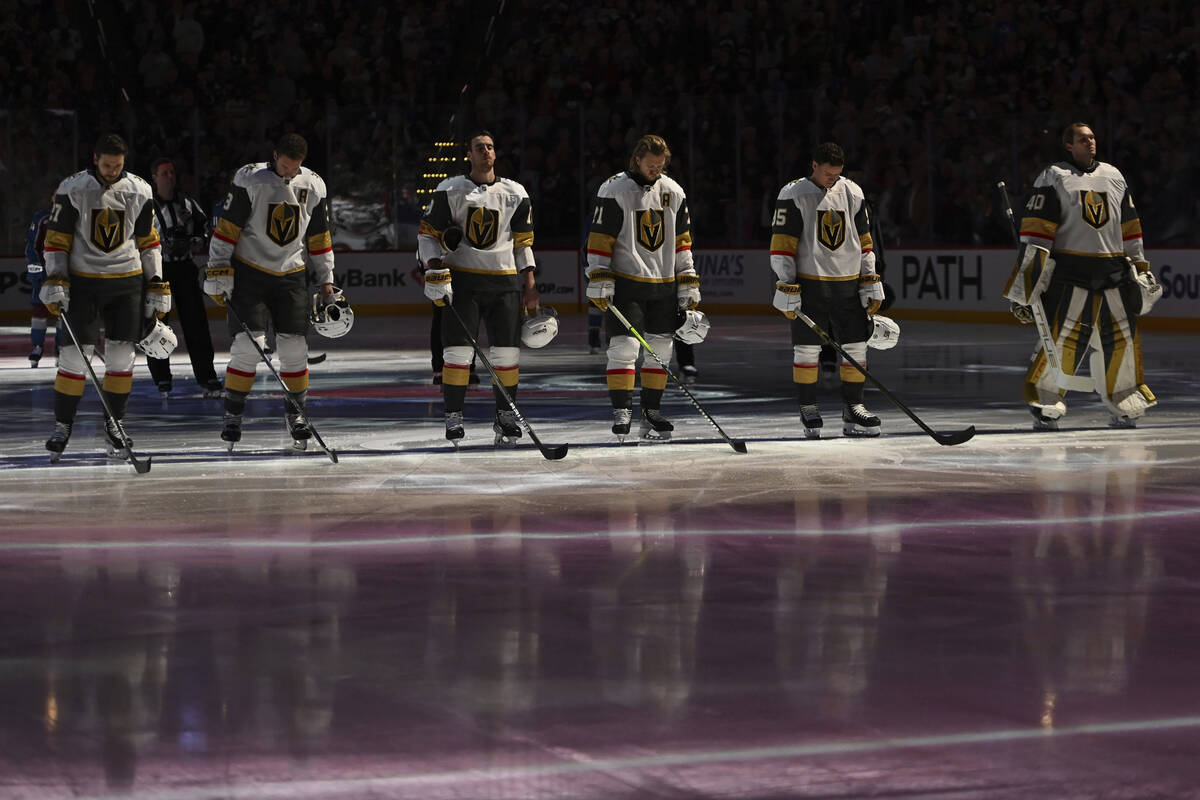 Members of the Vegas Golden Knights stand during the singing of the Star Spangled Banner prior ...