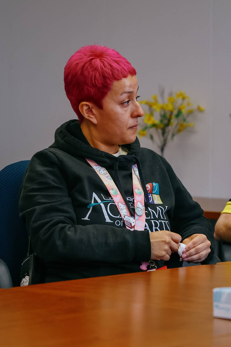Las Vegas Academy of the Arts campus monitor Rosemarie Rosales tears up as she and a group of L ...