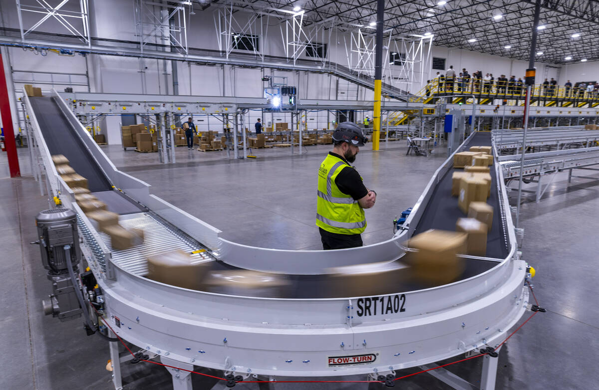 Completed boxes of products move along their sorting conveyor during a tour of the new distribu ...