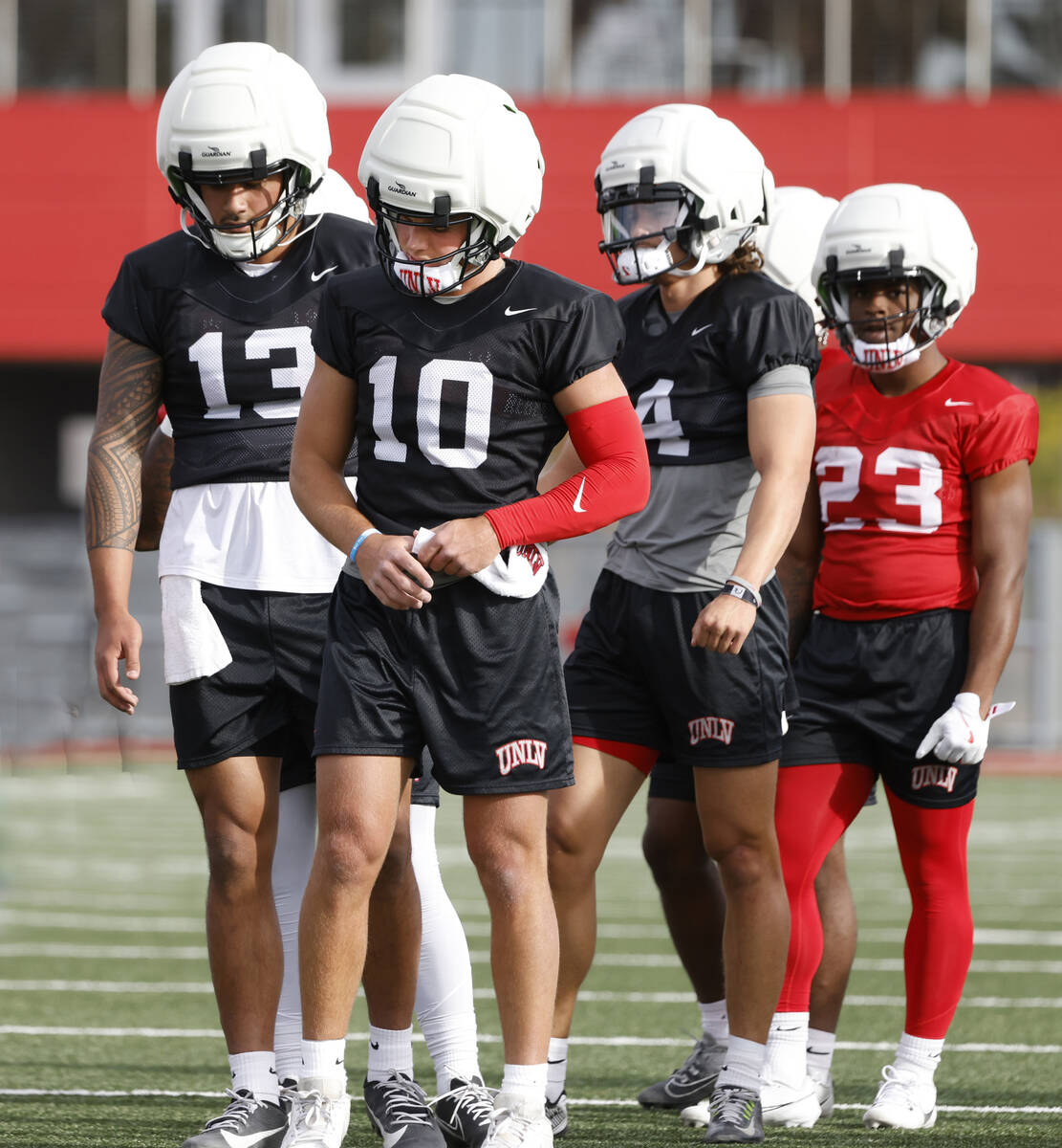 UNLV quarterbacks Cameron Friel (13) Anthony Colandrea (10) and Gael Ochoa (14) take the field ...