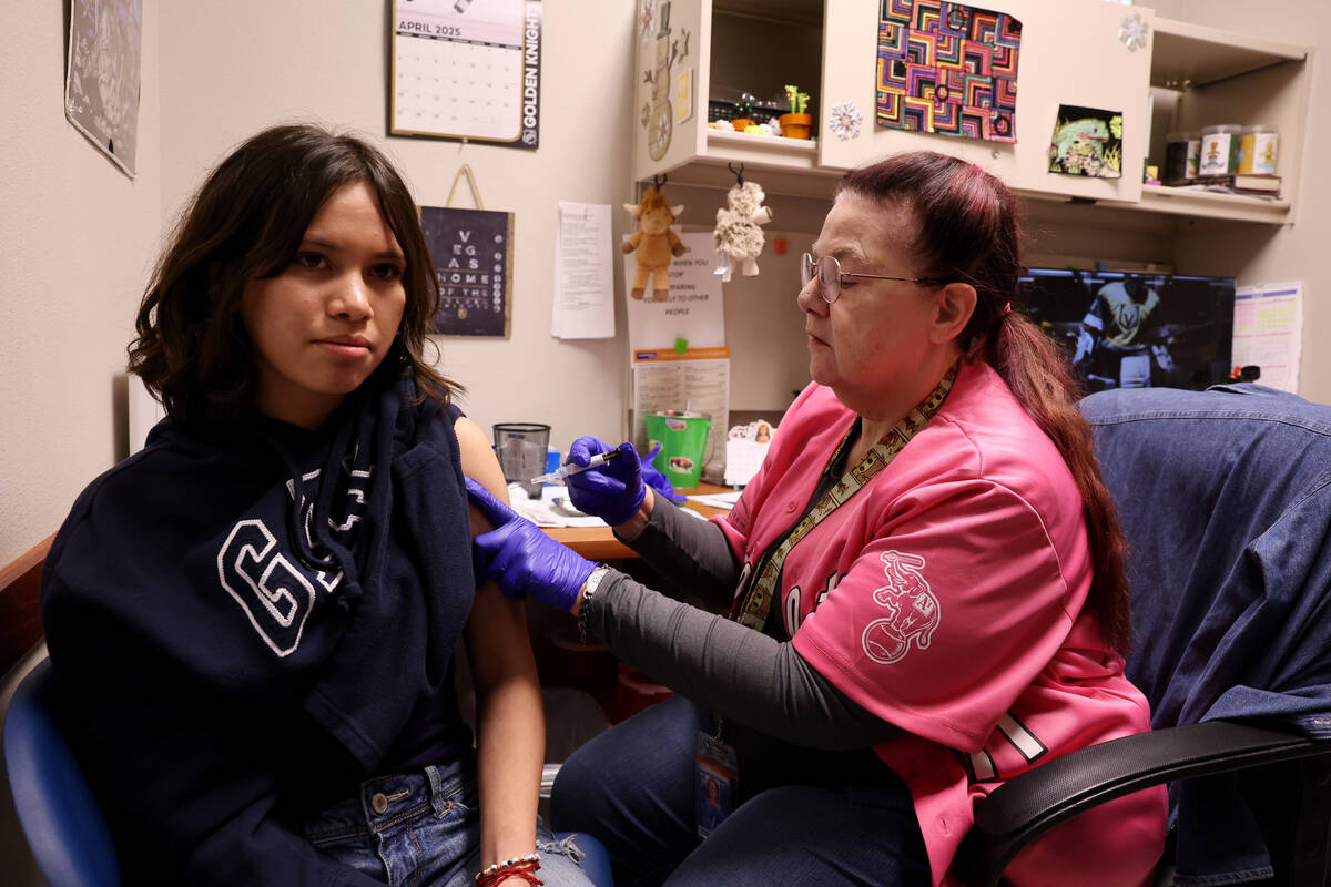 Fourteen-year-old Valentina Rodriguez Rosales gets a vaccination from AnnMarie Homer at Souther ...