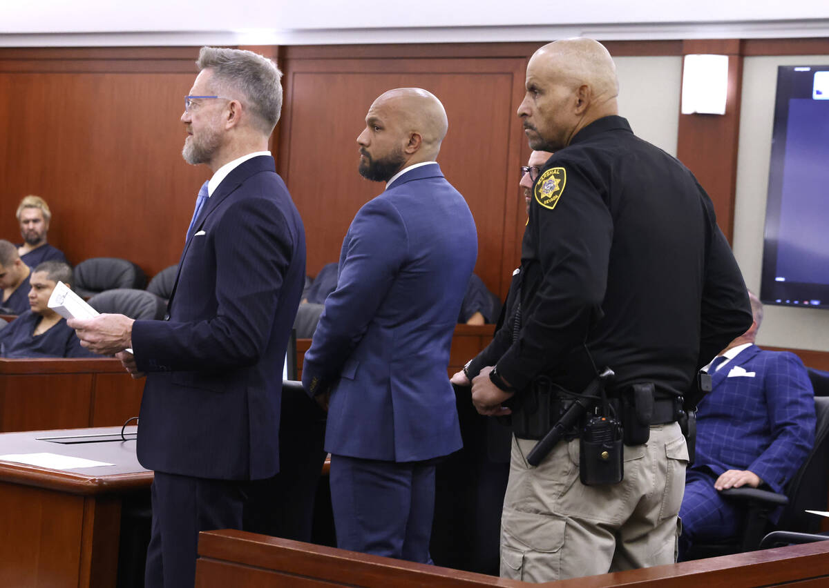 Metropolitan Police Department Sgt. Kevin Menon, center, accused of misconduct and possession o ...