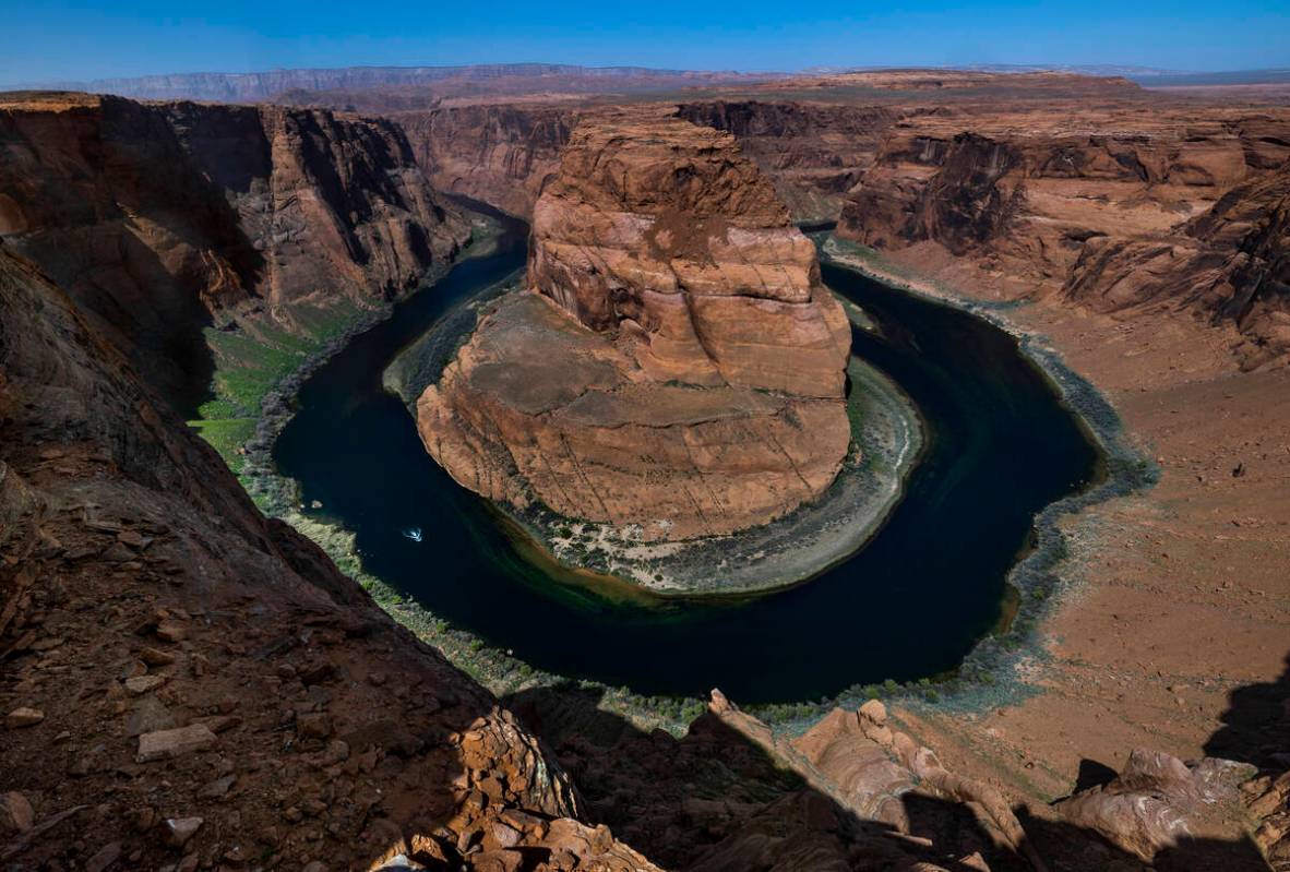 A boat cruises along the Colorado River near Horseshoe Bend on April 18, 2023, in Page, Ariz. ( ...