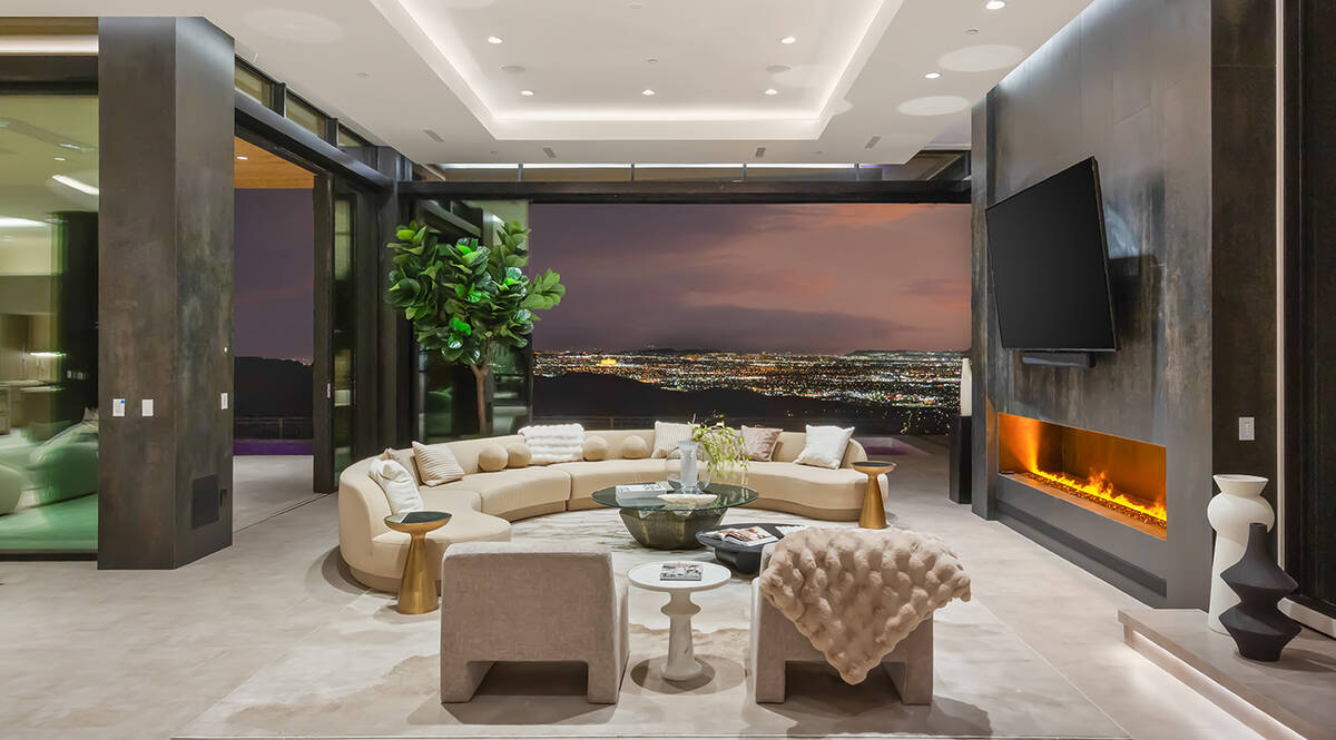 The two-story home that measures 10,459 square feet has six bedrooms, eight baths and a six-car ...