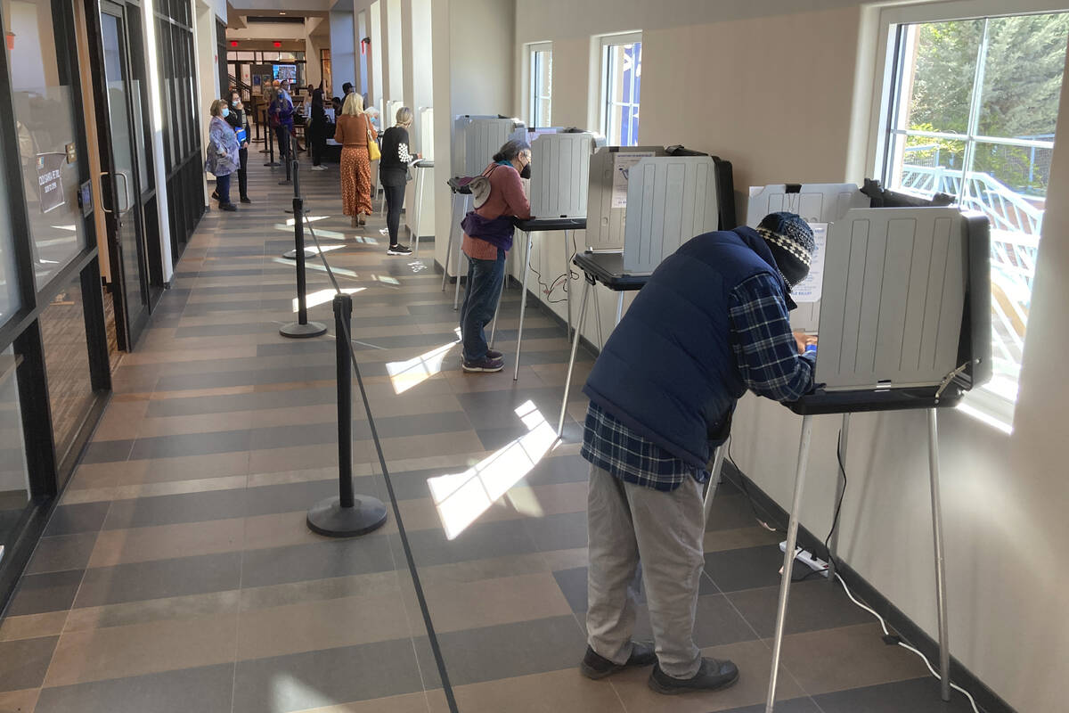 Santa Fe County, N.M., residents fill out general election ballots during the first day of gene ...