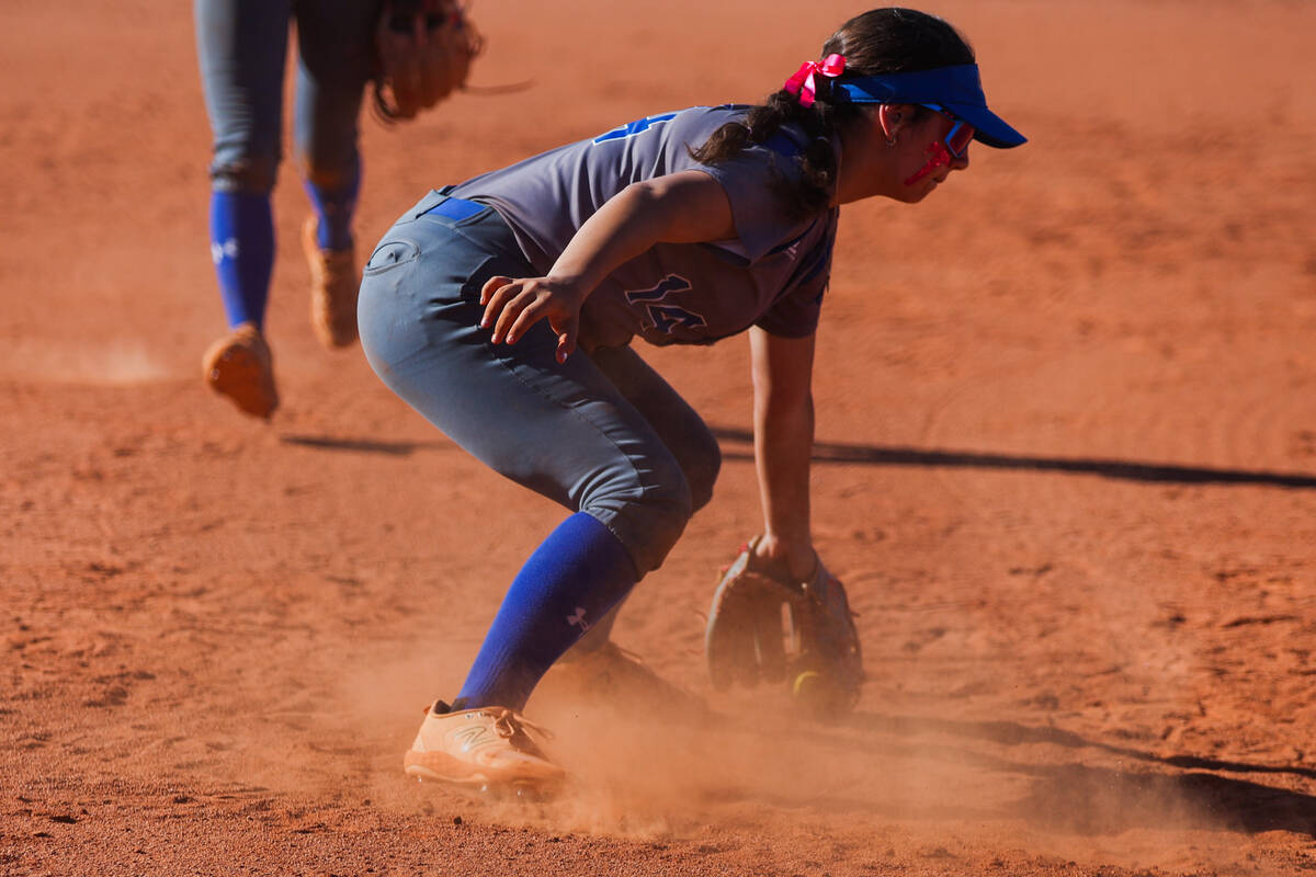 Basic softball player Adriana Skoczylas grabs the ball during a softball game between Basic and ...