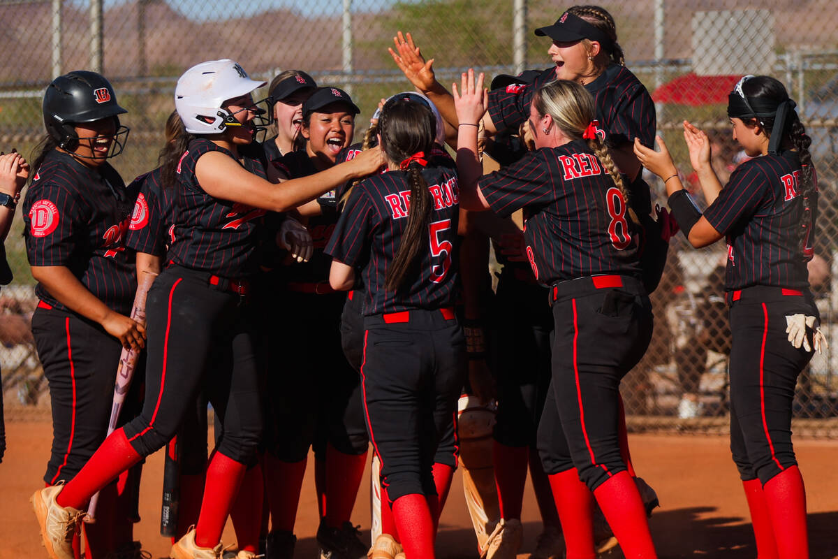 Doral Academy players celebrate during a softball game between Basic and Doral Academy at Basic ...