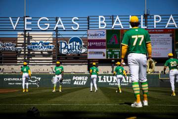 Athletics players warm up before playing the Arizona Diamondbacks during a Big League Weekend b ...