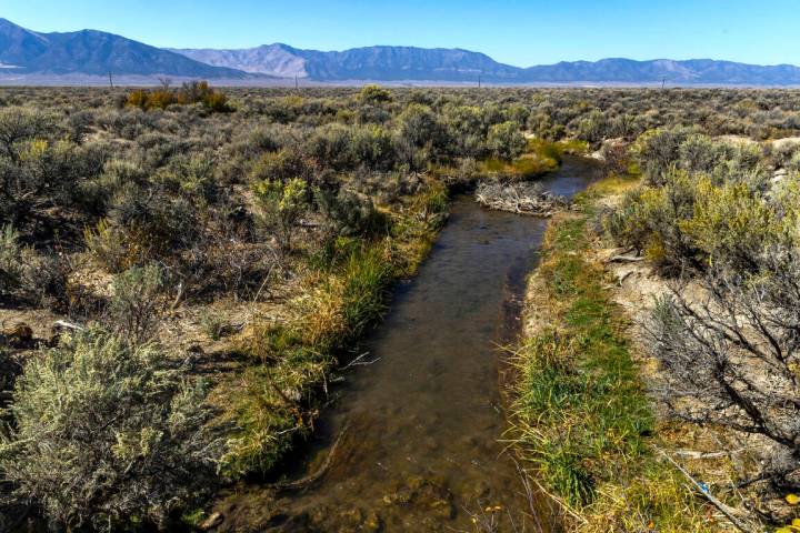 Water flows out from a creek, part of the hydrological basin that serves White Pine County, on ...