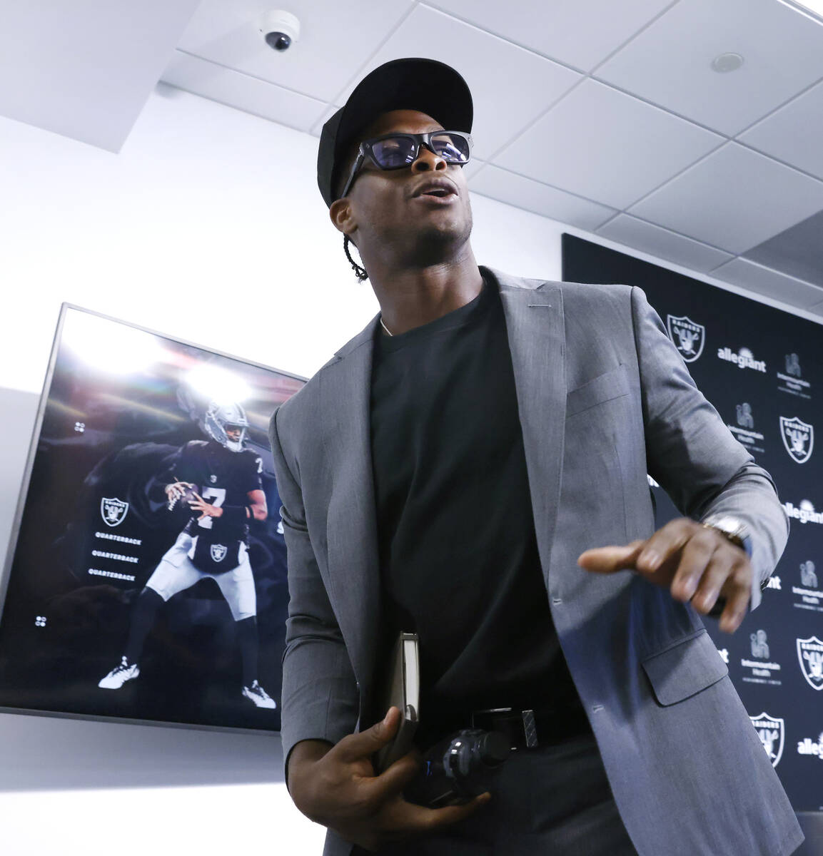 Geno Smith leaves the podium after being introduced to a media as new Raiders quarterback at th ...