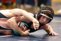 SLAM Academy’s Drake Hooiman, right, places Liberty’s Wyatte Nicholson, left, int ...