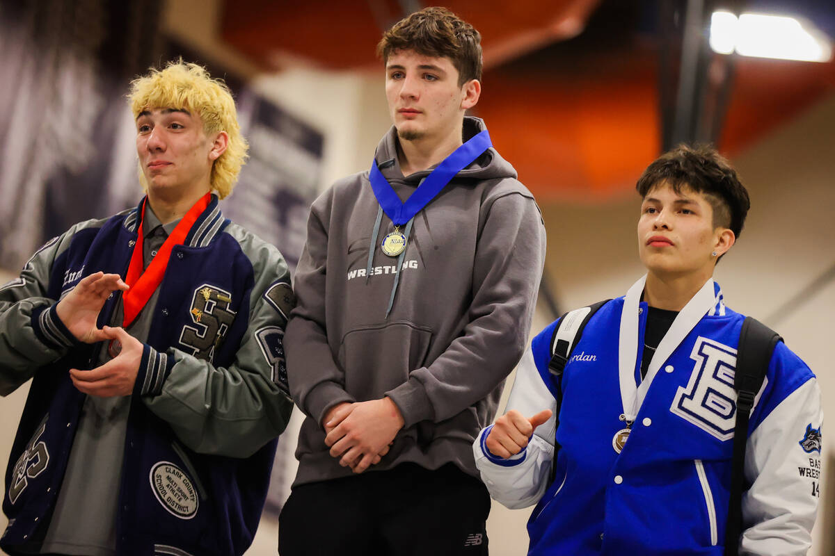 SLAM Academy wrestler Drake Hooiman (middle) wears his medal after getting first place in the 1 ...
