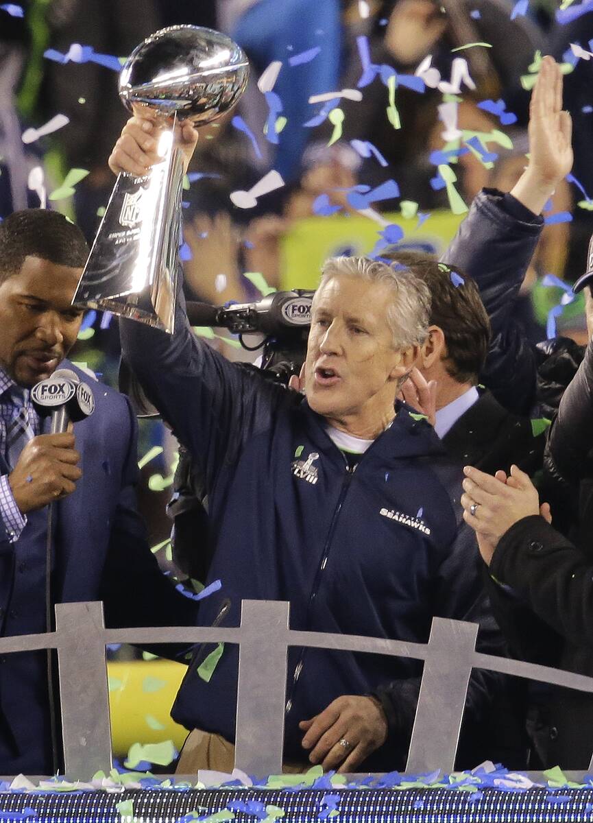 Seattle Seahawks head coach Pete Carroll holds up the Lombardi Trophy after winning the NFL Sup ...