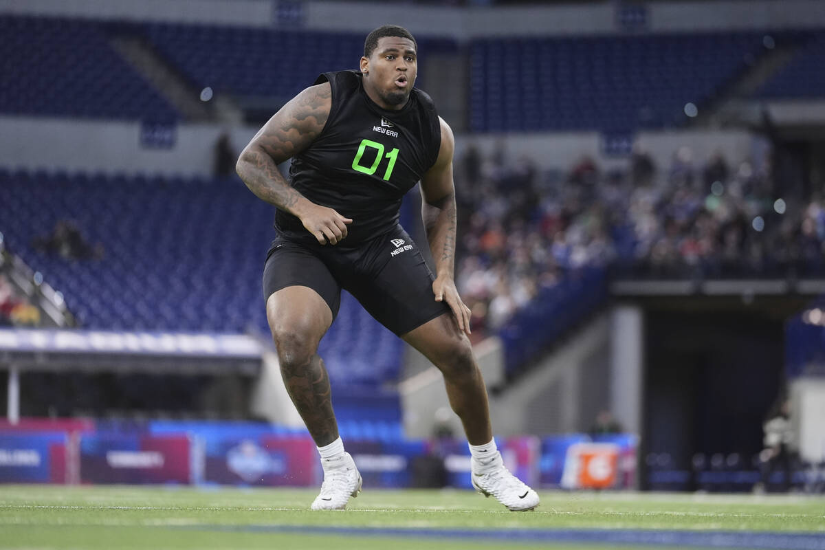 Texas offensive lineman Kelvin Banks Jr. runs a drill at the NFL football scouting combine in I ...