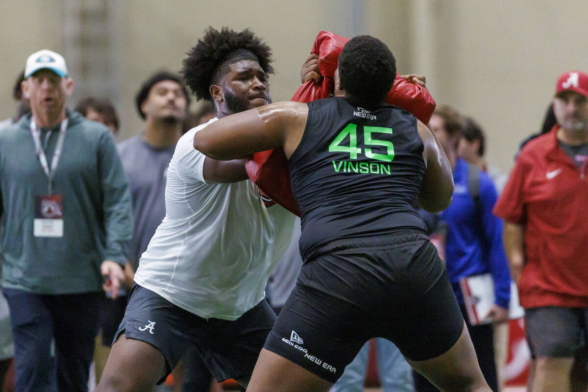 Former Alabama offensive lineman Tyler Booker, left, works against former Alabama A&M offen ...