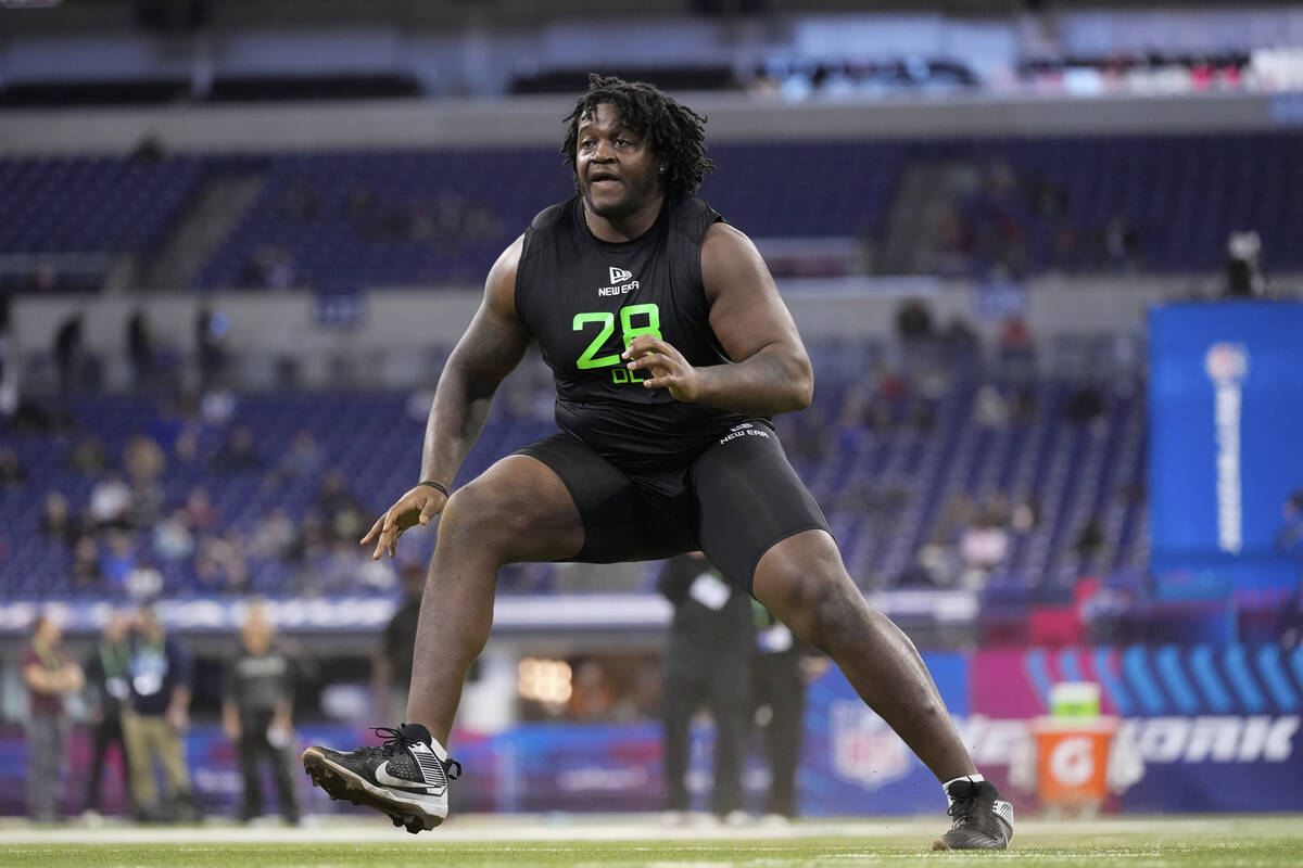 Missouri offensive lineman Armand Membou runs a drill at the NFL football scouting combine in I ...