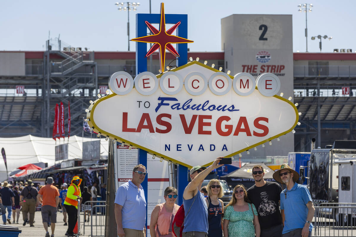 Fans take a group photo while entering the track area during qualifying for the NHRA 4-Wide Nat ...