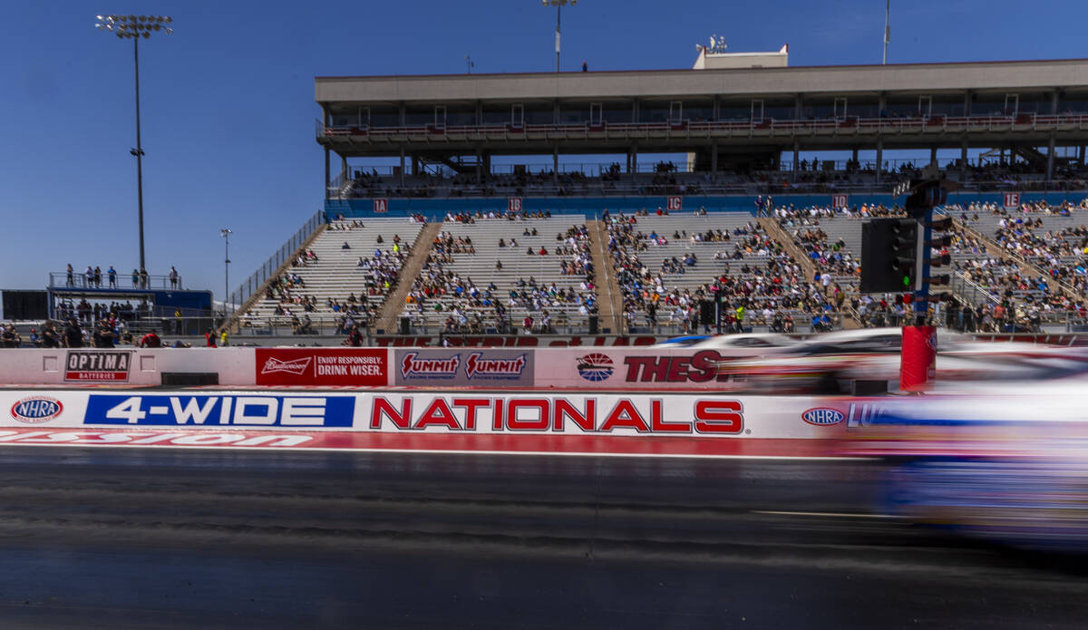 Cars come off the start line during qualifying for the NHRA 4-Wide Nationals at The Strip from ...