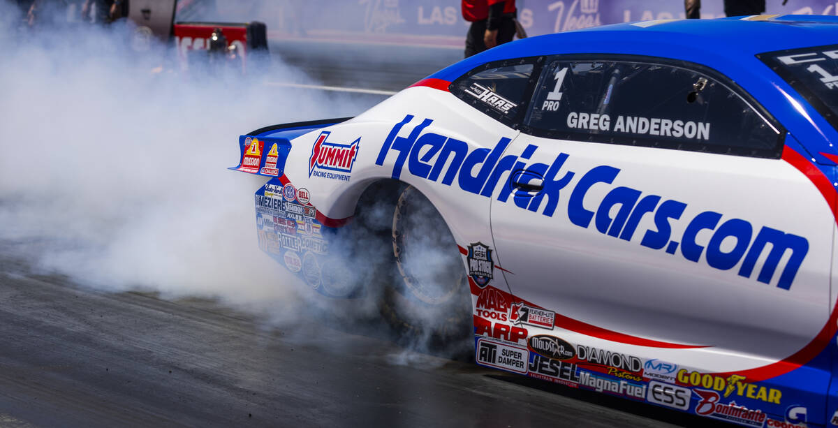 Pro Stock driver Greg Anderson warms up his tires at the start line during qualifying for the N ...