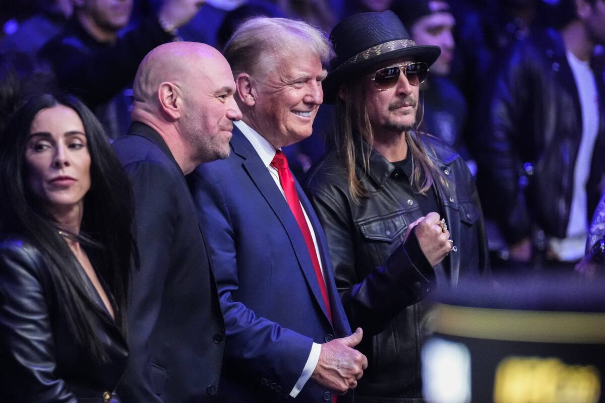 UFC president Dana White, second from left, and Kid Rock, right, pose for photographs with Pres ...