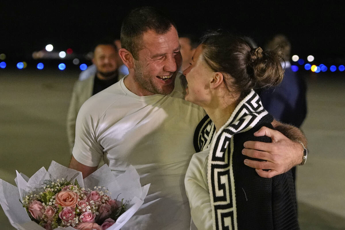 Ksenia Karelina walks with her fiancé, professional boxer Chris van Heerden, as she arrive ...