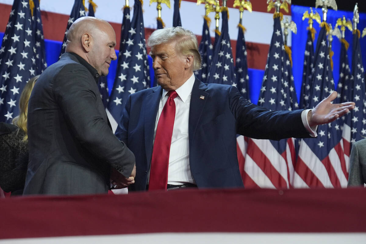 President Donald Trump, the then nominee, talks with UFC CEO Dana White at an election night wa ...
