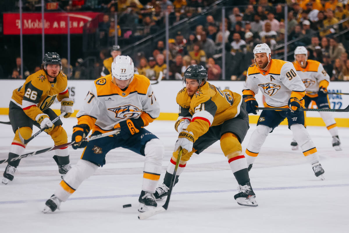 Golden Knights center Brett Howden (21) and Nashville Predators right wing Luke Evangelista (77 ...