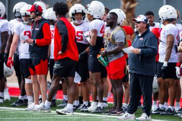 UNLV defensive coordinator Paul Guenther, right, yells from the sidelines during football sprin ...
