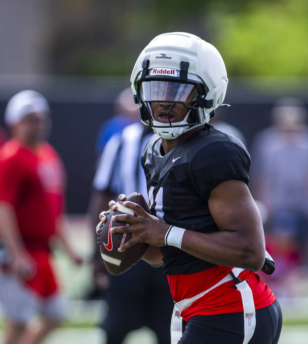 UNLV quarterback Alex Orji (11) eyes a receiver during football spring practice at the Fertitt ...