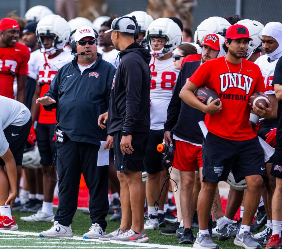 UNLV defensive coordinator Paul Guenther, left, talks on the sidelines during football spring p ...