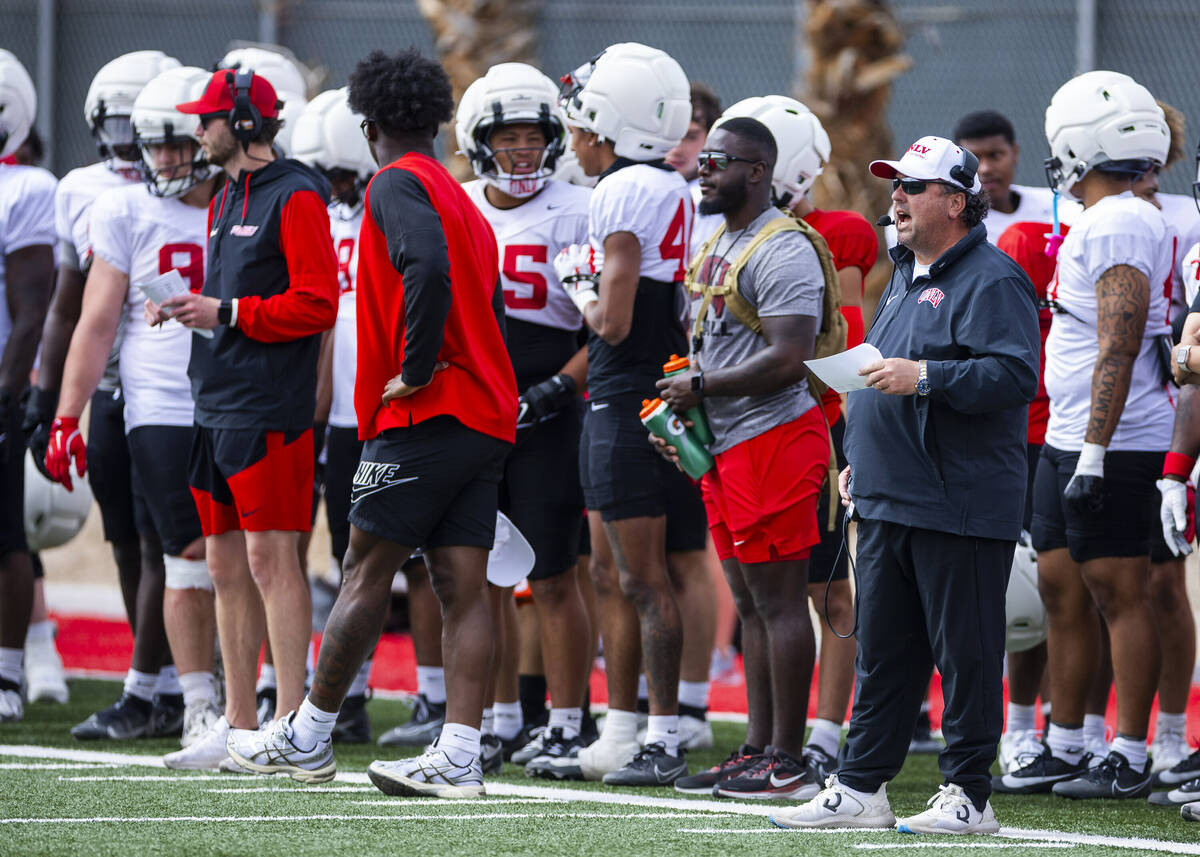 UNLV defensive coordinator Paul Guenther, right, yells from the sidelines during football sprin ...