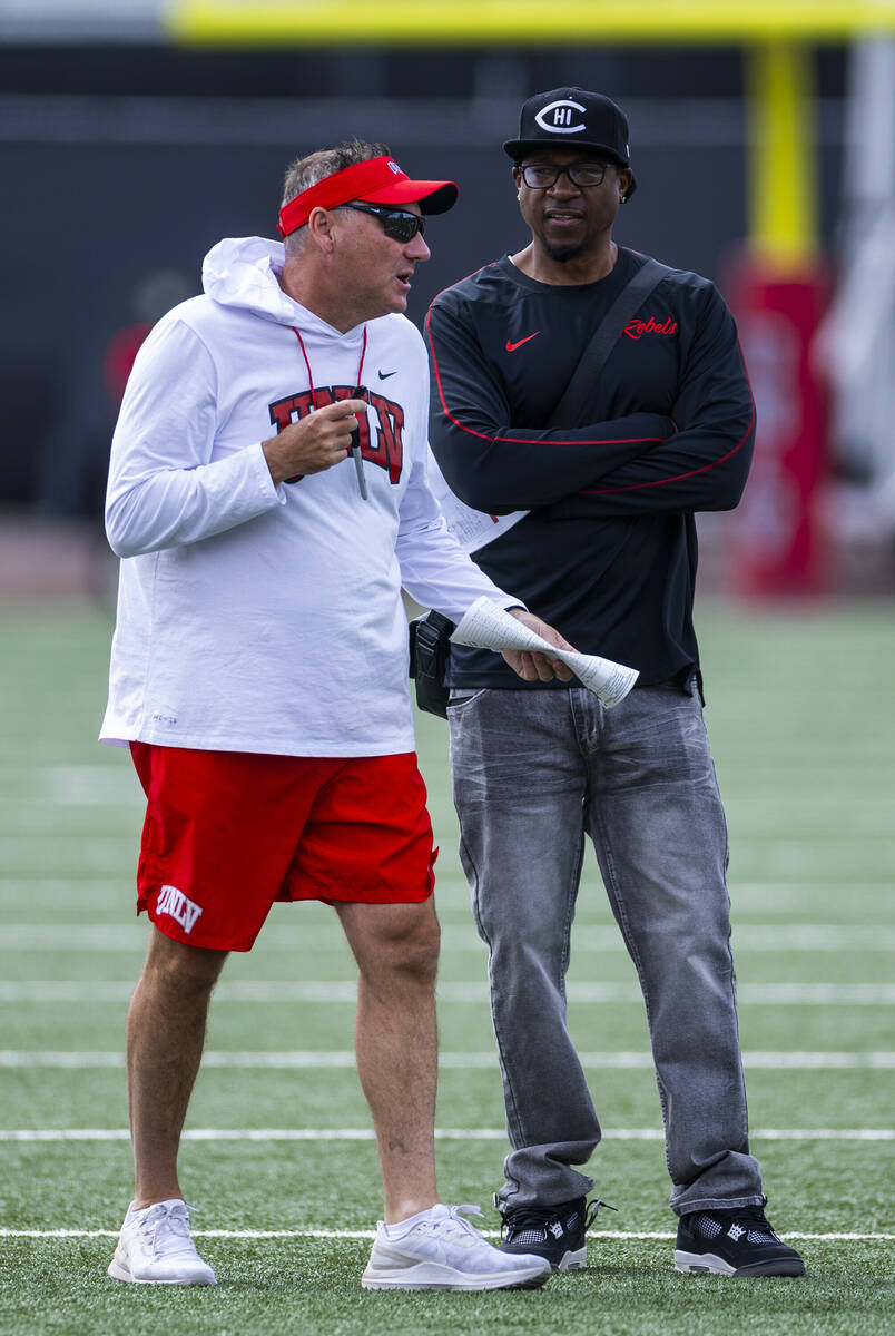 UNLV head coach Dan Mullen talks with other coaches during football spring practice at the Fert ...