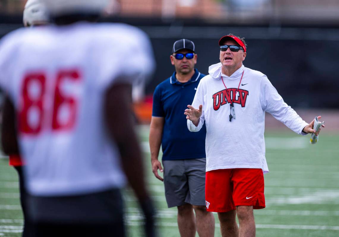 UNLV head coach Dan Mullen talks with players during football spring practice at the Fertitta F ...