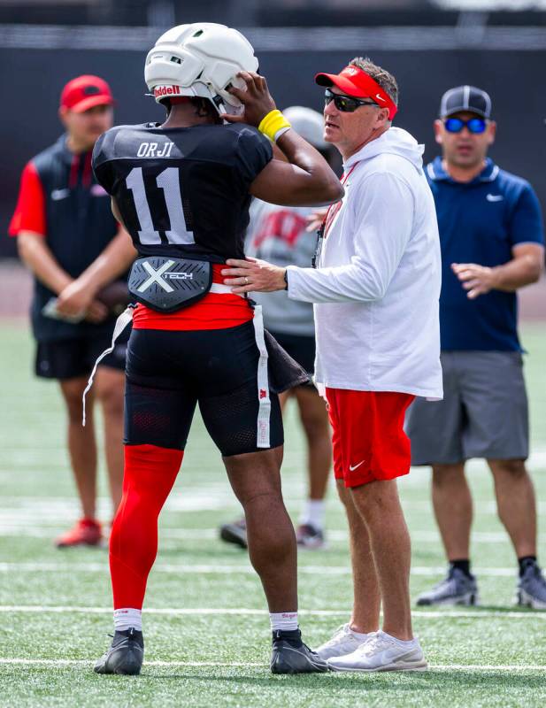 UNLV quarterback Alex Orji (11) chats with head coach Dan Mullen while running the offense duri ...