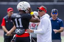 UNLV quarterback Alex Orji (11) chats with head coach Dan Mullen while running the offense duri ...