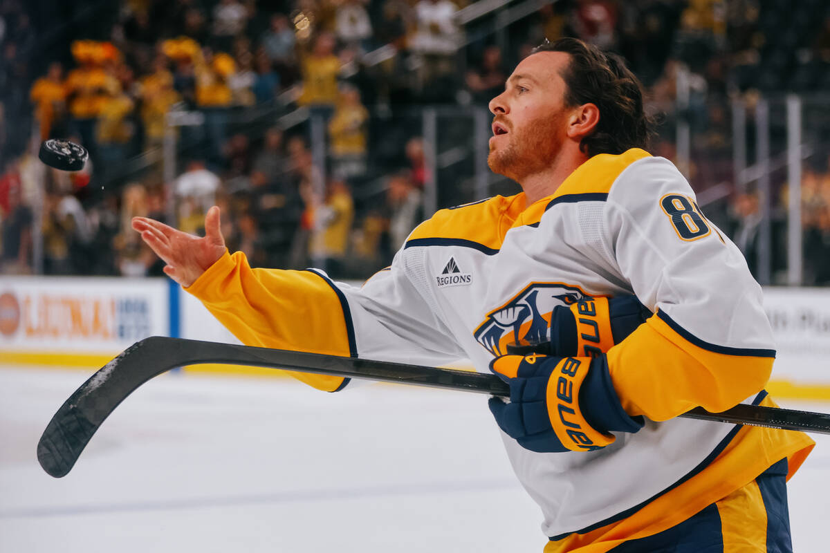 Nashville Predators center Jonathan Marchessault (81) tosses pucks into the crowd before the la ...