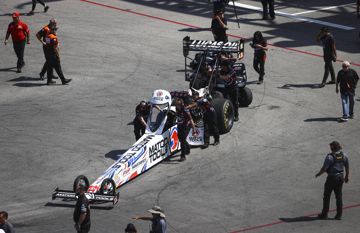 Top Fuel driver Antron Brown is moved to the track during the NHRA 4-Wide Nationals at The Stri ...