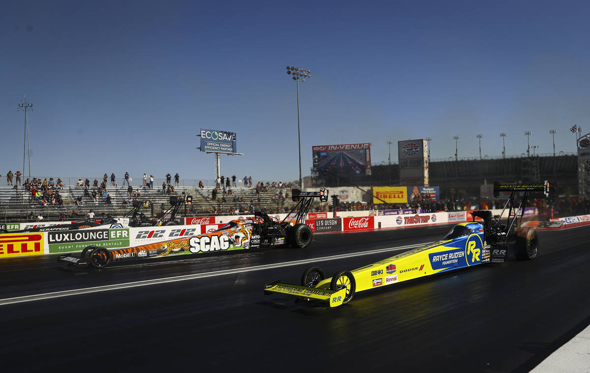 Top Fuel drivers Justin Ashley, left, and Tony Stewart take off from the start in the final rou ...