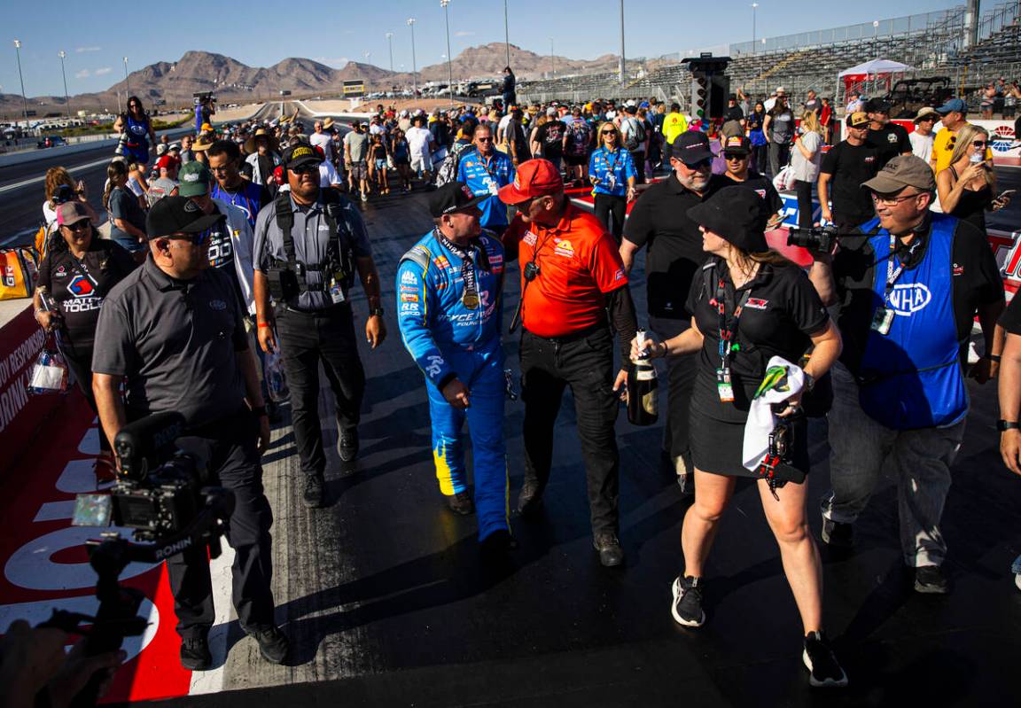 Top Fuel driver Tony Stewart makes his way off the track while celebrating his victory in the N ...