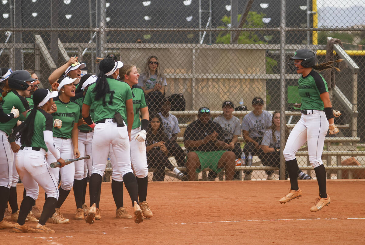 Palo Verde players celebrate a home run by Palo Verde's Taylor Johns, right, during a softball ...
