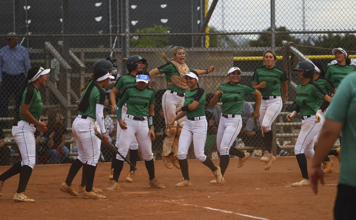 Palo Verde players run to home plate to celebrate a home run by Palo Verde's Taylor Johns, not ...