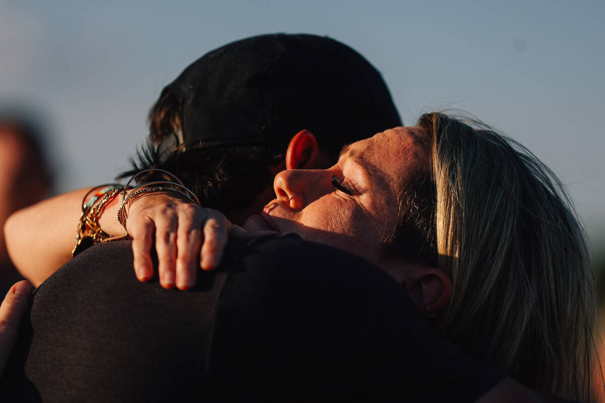 Kelly Dodder is comforted during a vigil for her husband, Jordon Dodder, who died after a crash ...