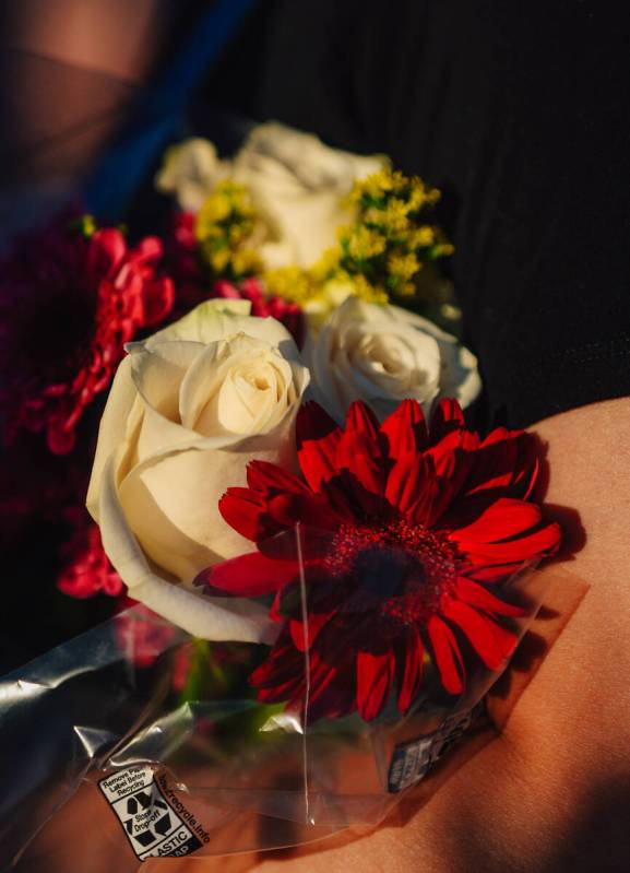 Flowers are held during a vigil for Jordon Dodder, who died after a crash at the intersection o ...