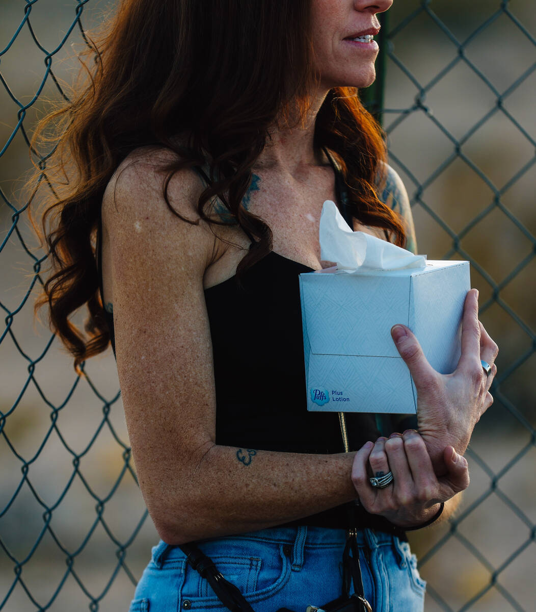 A mourner holds a box of tissues during a vigil for Jordon Dodder, who died after a crash at th ...