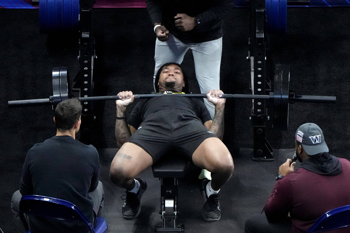 Marshall defensive lineman Mike Green lifts weights at the NFL football scouting combine, Frida ...