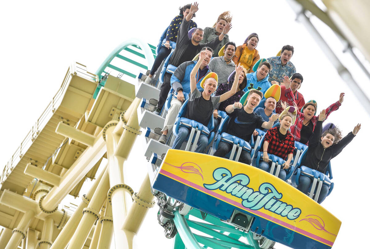 Visitors at Knott's Berry Farm ride the HangTime roller coaster during its first day of public ...