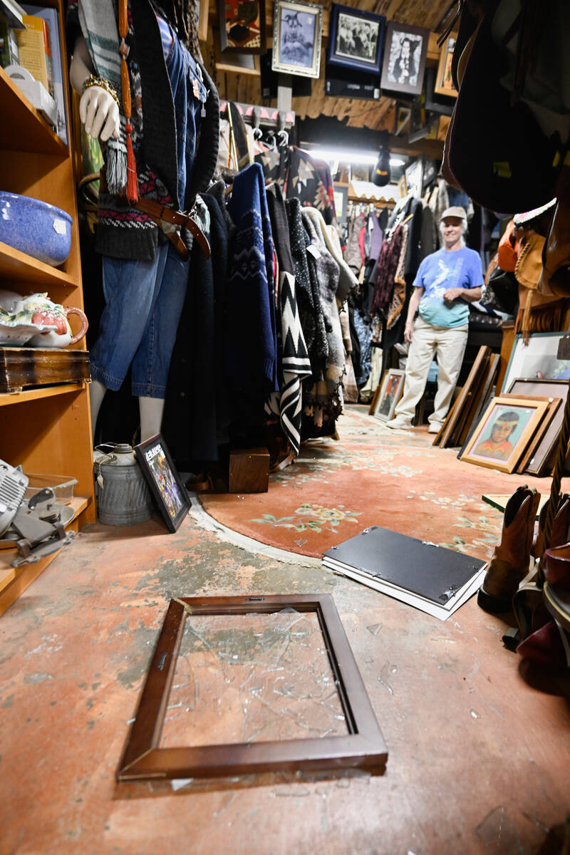 Tracy Turner, owner of the Wynola Junction, looks over pictures that fell from shelves when a e ...