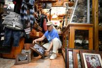 Tracy Turner, owner of the Wynola Junction, looks over pictures that fell from shelves when a e ...